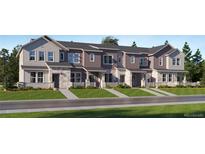 Modern townhome exterior with stone accents and landscaping at 1950 S Haleyville Way, Aurora, CO 80018