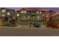 Charming townhome with attached garages, front decks, and lush landscaping at 1552 Live Oak Rd, Castle Rock, CO 80104