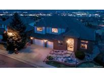 Charming two-story brick home featuring a spacious three-car garage and beautifully landscaped front yard at 16261 W Ellsworth Ave, Golden, CO 80401