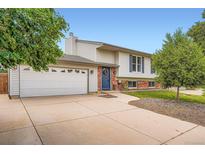 Charming two-story home with a brick and siding exterior, large driveway and well-manicured lawn at 19196 E Kansas Dr, Aurora, CO 80017