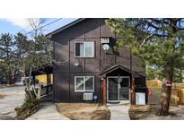 Charming home featuring a covered porch and lush landscaping, perfect for enjoying the outdoors at 3046 S Alpine Dr, Evergreen, CO 80439