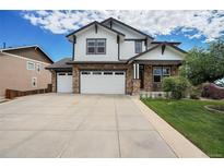 Charming two-story home featuring a three-car garage, stone accents, and a well-manicured front yard at 2314 Fairway Wood Cir, Castle Rock, CO 80109