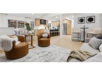 Inviting living space with an open layout, seamlessly connecting the living room and modern kitchen at 12445 W 19Th Pl, Lakewood, CO 80215