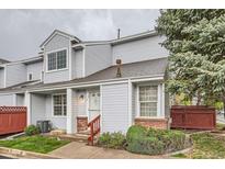 Charming two-story townhome with light blue siding, well-maintained landscaping, and a welcoming entrance at 12282 Bannock Cir # A, Denver, CO 80234
