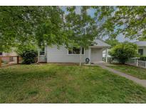 Charming single-story home featuring a well-manicured lawn and beautiful trees in a cozy neighborhood at 3256 S Ogden St, Englewood, CO 80113