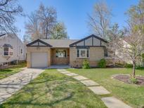 Charming brick home featuring a well-manicured lawn and inviting walkway at 600 E Amherst Ave, Englewood, CO 80113