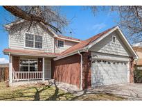 Charming two-story home featuring a brick facade, a two-car garage, and well-maintained landscaping at 2791 S Bahama Ct, Aurora, CO 80013