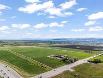 Expansive aerial view of land with a beautiful view of the horizon and large open green field at 1805 W County Road 8, Berthoud, CO 80513