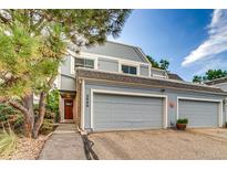 Charming townhome showcasing a two-car garage and well-maintained landscaping at 2980 S Parker Ct, Aurora, CO 80014