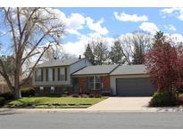 Charming two-story home featuring a well-maintained lawn and attached two car garage at 308 Baron Ave, Lafayette, CO 80026