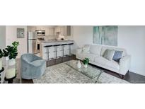 Bright living room featuring sleek furniture, modern decor, and an open floor plan into the kitchen at 5120 Williams Fork Trl # 210, Boulder, CO 80301
