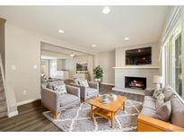 Inviting living room featuring a fireplace, two chairs, a couch and recessed lighting at 13003 W 20Th Ave, Golden, CO 80401