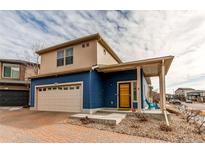 Two-story craftsman style home with a blue exterior and a covered porch at 19149 E 55Th Ave, Denver, CO 80249