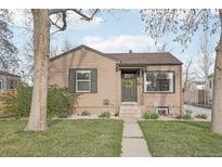 Charming single-story home with a well-maintained lawn and inviting front entrance adorned with a wreath at 4180 S Elati St, Englewood, CO 80110