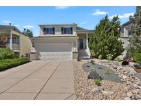 Charming two-story home with a two-car garage and beautifully landscaped front yard at 20356 Willowbend Ln, Parker, CO 80138