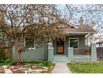 Charming home featuring a cozy front porch, walkway and well-manicured lawn at 2664 Dahlia St, Denver, CO 80207