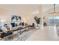 Bright living room with a neutral color palette, modern furnishings, and lots of natural light at 9383 Cobblecrest Dr, Highlands Ranch, CO 80126