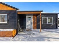 Stylish, renovated home with a modern front door entrance and snowy winter scenery at 2756 S Hooker St, Denver, CO 80236