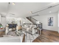 Bright living room with hardwood floors and a comfortable sofa at 163 S Harrison St, Denver, CO 80209
