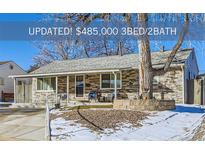 Charming single-story home featuring a stone facade, well-manicured yard, and inviting front porch at 2701 S Knox Ct, Denver, CO 80236