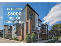 Modern townhome with brick accents, offering $5000 seller concession, set against a bright blue sky at 3795 Depew St # D, Wheat Ridge, CO 80212