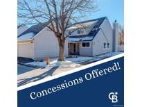 Charming two-story home with a well-maintained lawn and attached garage, perfect for families at 10395 Red Mountain E, Littleton, CO 80127