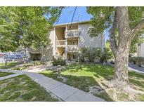 Charming two-story condo with lush landscaping, trees, and easy access to parking and outdoor spaces at 4068 S Atchison Way # 101, Aurora, CO 80014