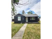 Charming one-story home featuring a cozy front porch and well-maintained lawn at 1273 Newark St, Aurora, CO 80010
