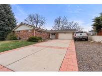 Charming single-story brick home with a spacious driveway and attached two-car garage at 748 W 100Th Ave, Northglenn, CO 80260