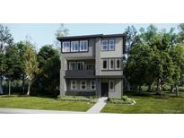 Contemporary three-story home with gray siding, black trim, balcony, and manicured lawn at 7308 Waterleaf Trl, Littleton, CO 80125