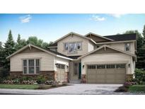 Charming two-story home with a large two car garage and stone accents near the front door at 14553 Hudson Way, Thornton, CO 80602