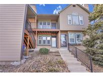 Inviting two-story townhome featuring a cozy balcony, a welcoming entrance, and traditional architectural charm at 17478 E Rice Cir # D, Aurora, CO 80015
