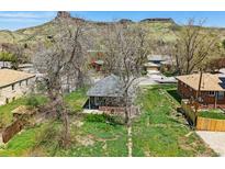 Charming bungalow with a front yard, mature trees, and mountain views at 1914 Washington Ave, Golden, CO 80401