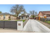 Charming home exterior featuring a long driveway and well-maintained landscaping at 825 S Quitman St, Denver, CO 80219