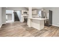 Open kitchen with stainless steel appliances and quartz countertop at 825 S Quitman St, Denver, CO 80219