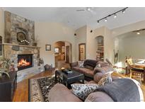 Cozy living room with stone fireplace, hardwood floors, and comfortable seating at 493 Cr 672, Breckenridge, CO 80424