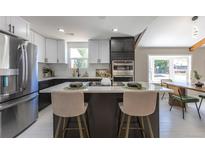 Stylish kitchen with an island with seating, and stainless steel appliances at 5195 Allison St, Arvada, CO 80002