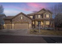 Charming two-story home features stone accents, a three-car garage, and a cozy front porch at 13987 Lexington Dr, Parker, CO 80134