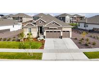Charming single-Gathering home with a manicured lawn, three-car garage and inviting entrance at 8890 S Quatar Ct, Aurora, CO 80016