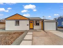 Charming single-story home featuring a bright yellow front door and attached garage in a desirable neighborhood at 2360 S Julian St, Denver, CO 80219