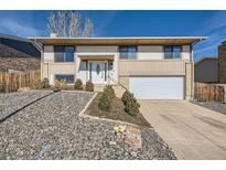 Charming two-story home with front yard landscaping and attached two-car garage at 13751 W Warren Dr, Lakewood, CO 80228