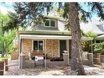 Charming front exterior of a home with a welcoming porch and stone facade at 2156 Federal Blvd, Denver, CO 80211