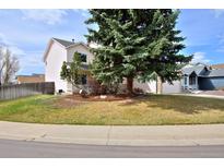 Charming two-story home with mature landscaping and well-maintained front yard at 11976 W Brandt Pl, Littleton, CO 80127