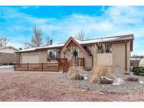 Charming single-story brick home with a well-maintained front yard and covered entry at 779 Alkire St, Lakewood, CO 80401