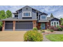 Beautiful two-story home with brick and blue siding, large garage, and well-maintained landscaping at 7831 W 109Th Ave, Westminster, CO 80021