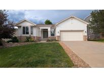 Charming single-Gathering home with lush lawn and a two-car garage at 7410 Winter Berry Ln, Castle Pines, CO 80108