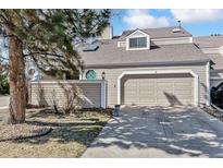 Charming exterior showcasing a two-car garage, decorative window and tasteful landscaping at 90 S Fraser Cir, Aurora, CO 80012