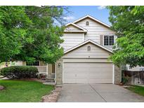 Charming two-story home with a two-car garage, well-maintained landscaping, and inviting curb appeal at 5337 S Ukraine Way, Aurora, CO 80015