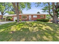 Charming brick home with well-maintained lawn and mature trees, offering great curb appeal at 2902 S Meade St, Denver, CO 80236