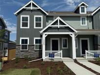 Beautiful townhome showcasing a well-manicured lawn and craftsman-style architecture at 15242 Detroit St, Thornton, CO 80602